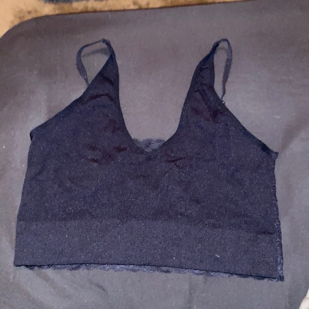 Black crop tank with adjustable straps and a lace back